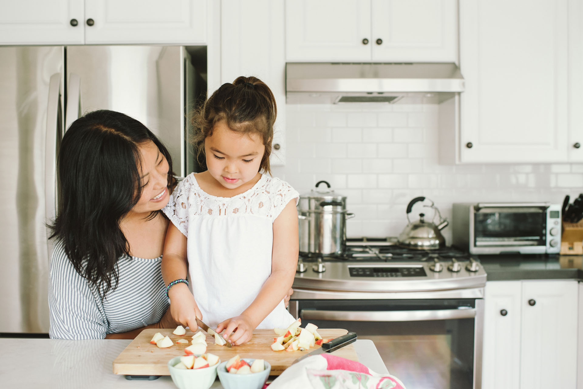 mother and daughter preparing fruit